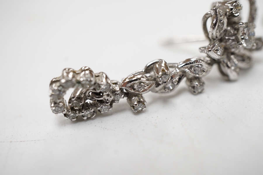 A pair of recent white metal and diamond cluster set drop earrings, of foliate design with pear shaped drops, overall 29mm.